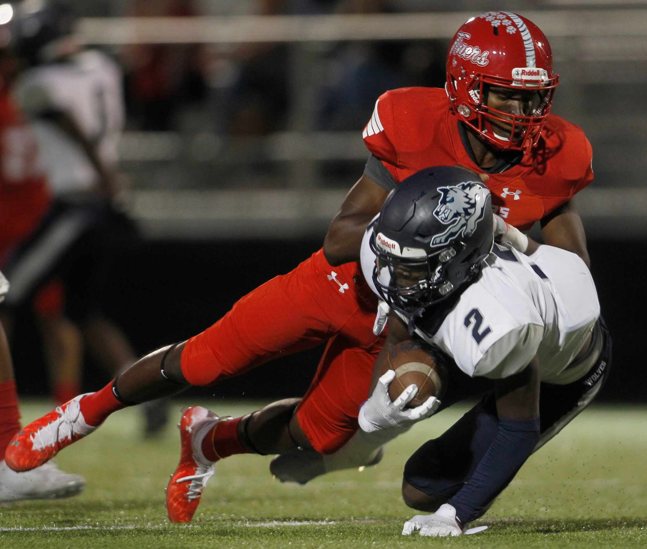 Carrollton Ranchview's Jamel Jones (2) is stopped for a loss as he is tackled by Terrell...