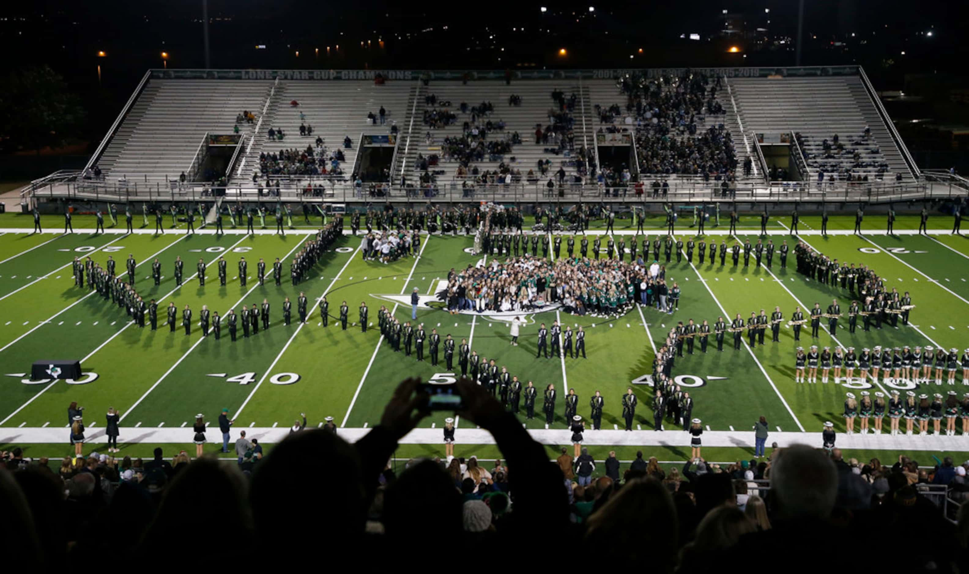 Southlake Carroll celebrates  the presentation of the Lone Star Cup at halftime of their...