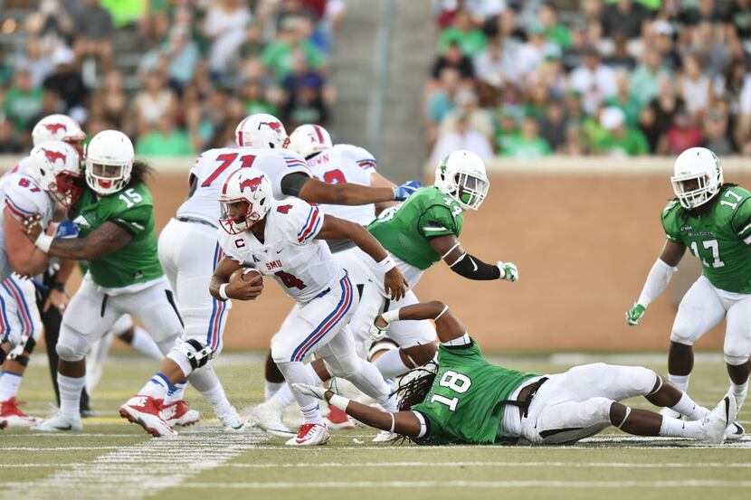 North Texas junior defensive end Joshua Wheeler (18) dives after Southern Methodist senior...