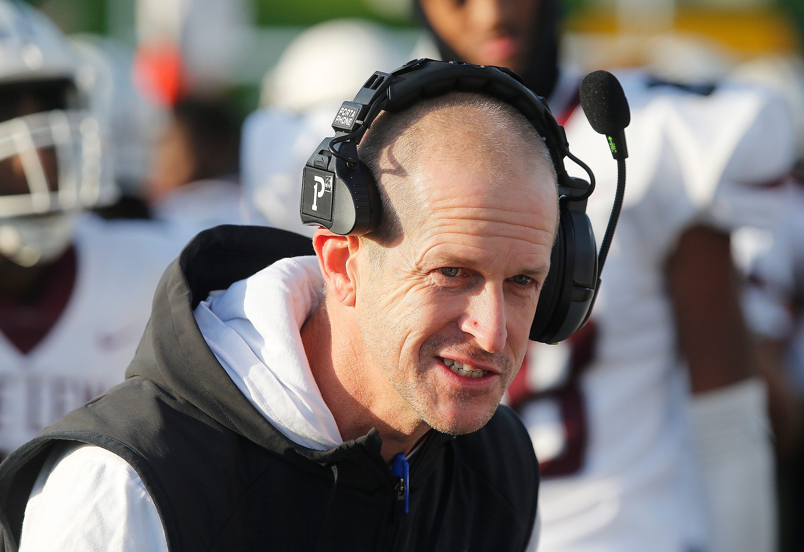 Lewisville High School head coach Michael Odle talks to a group of players during the second...