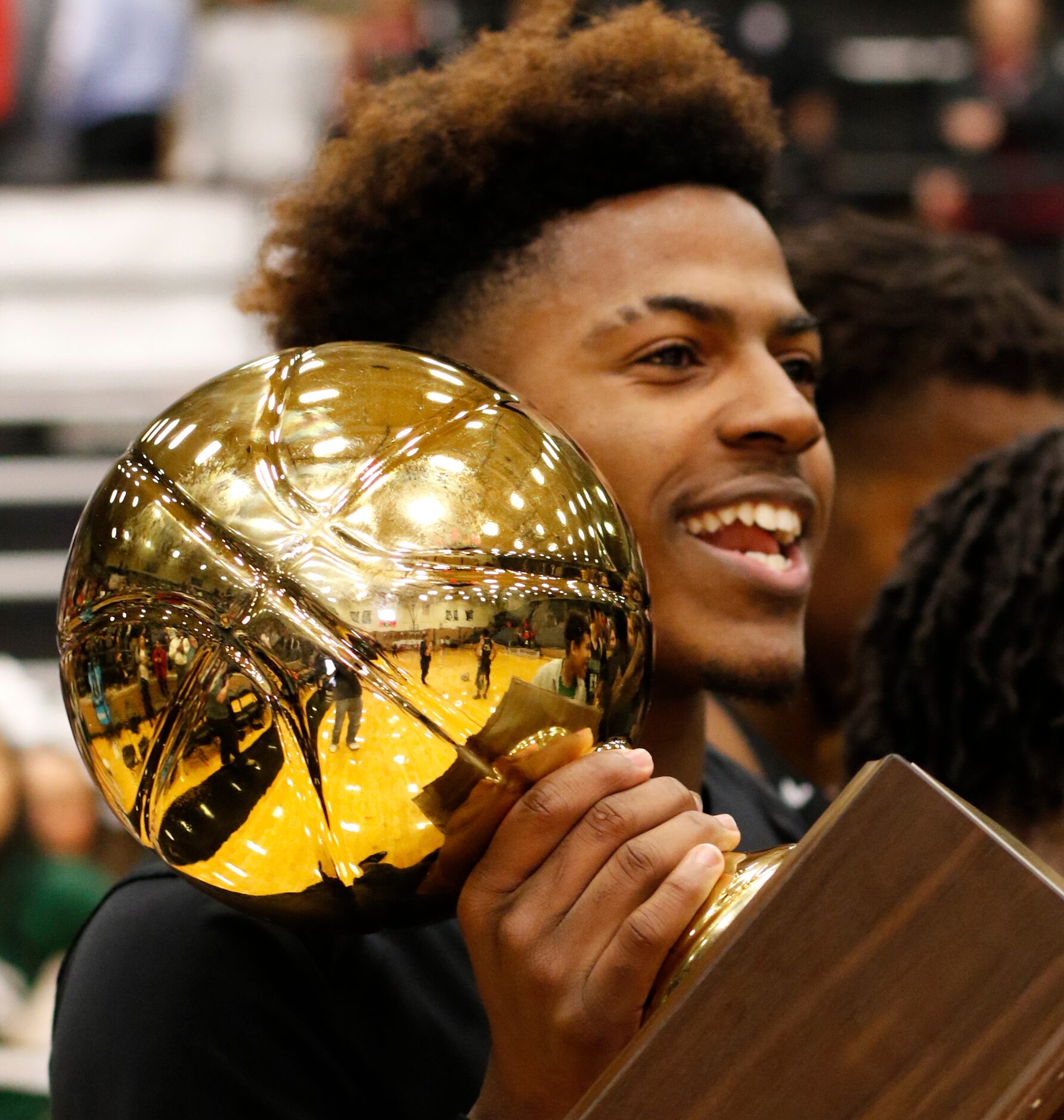 Waxahachie guard DMarion Collier (2) beams as he celebrates after Waxahachie claimed some...