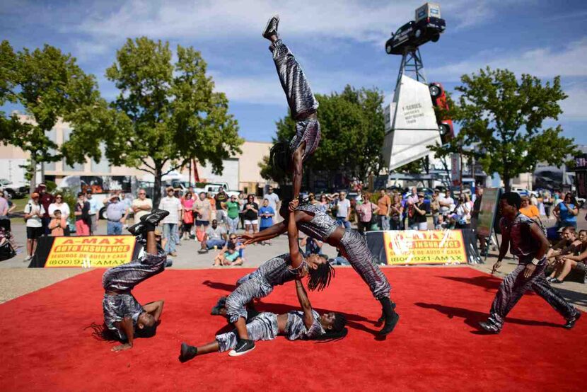 The acrobats perform several times a day near the Auto Show Truck Zone