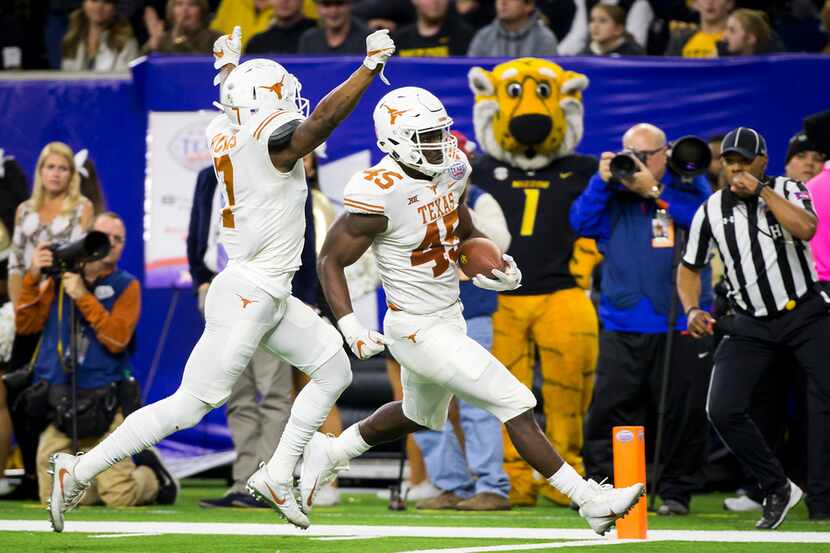 Texas linebacker Anthony Wheeler (45) returns a fumble 38-yards for a touchdown as defensive...