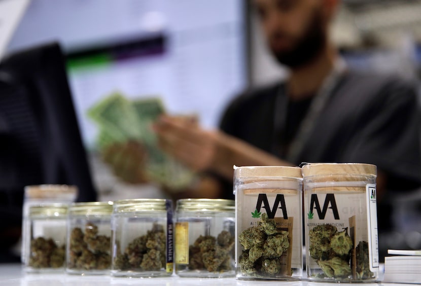 A cashier rings up a marijuana sale, July 1, 2017, at a cannabis dispensary in Las Vegas. 