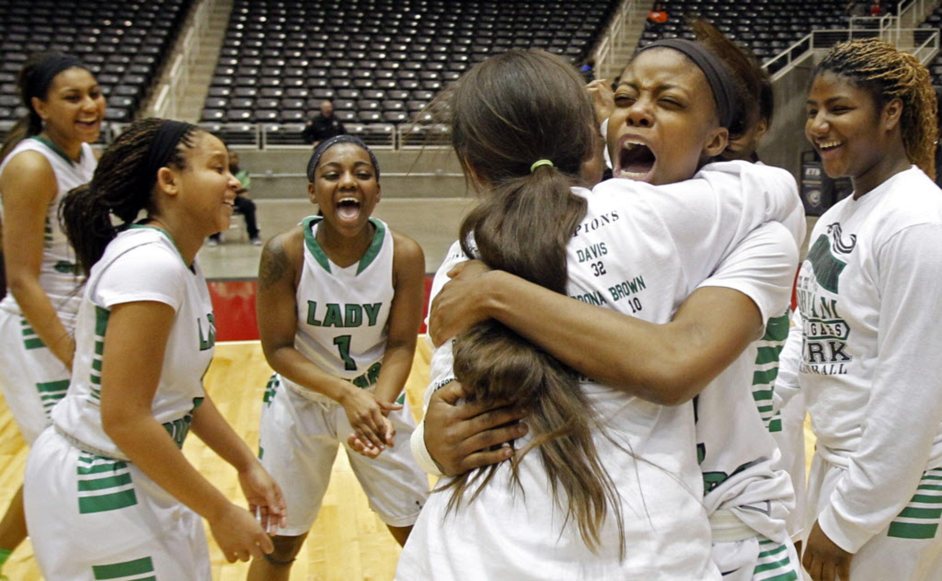 Bryan Adams players celebrate after winning the Class 5A Region II girls basketball...