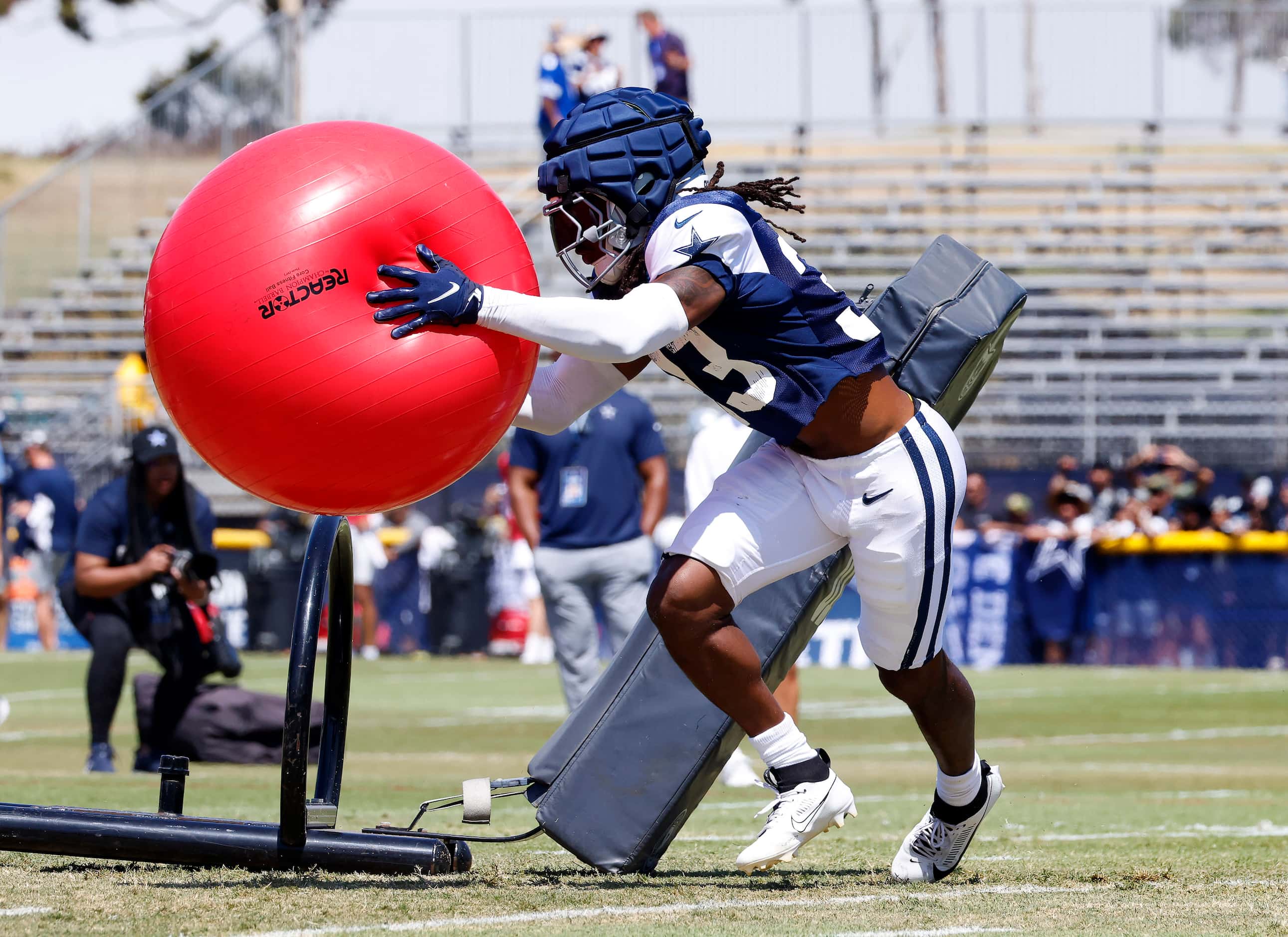 Dallas Cowboys safety Julius Wood (33) scoopes up an exercise ball after hitting a blocking...
