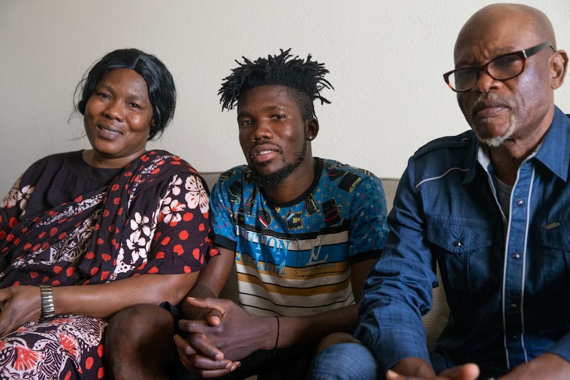 Isaac Alingabo (center), a refugee from the Democratic Republic of the Congo, poses for a...