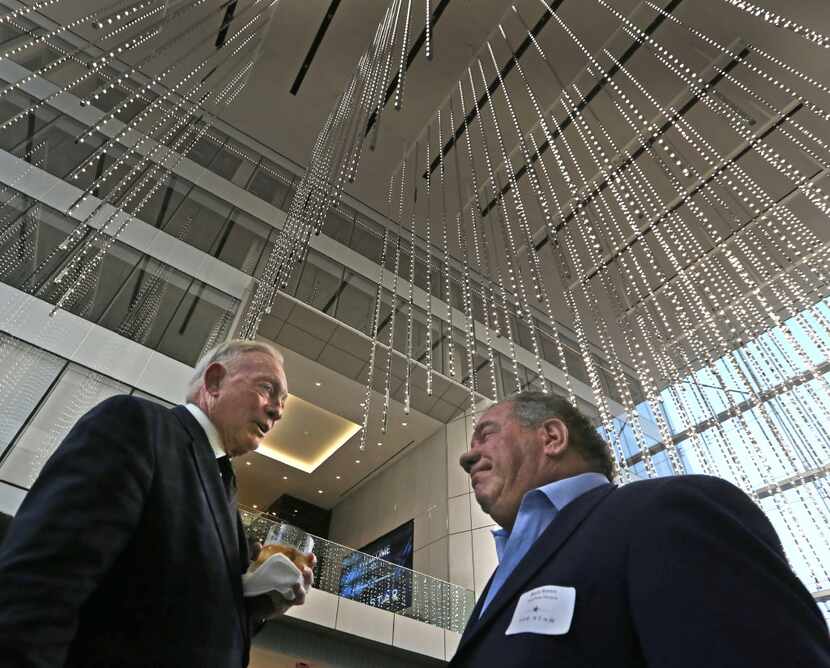 Dallas Cowboys owner Jerry Jones talks with Bruce Russo of Bruce Russo Designs as the Jones...