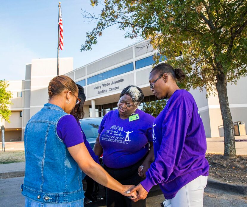 
Darlene Williby (center) prays with volunteers Sabra Taylor, Sandy Harris and Carla...