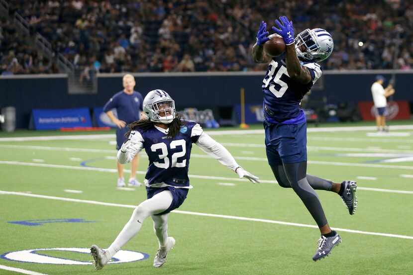 Cowboys safety Kavon Frazier (35) catches a pass intended for cornerback Donovan Olumba (32)...