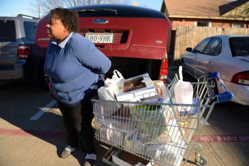 
Jacqueline Eaton loads groceries into her vehicle at the Cedar Hill Food Pantry on Jan. 3....