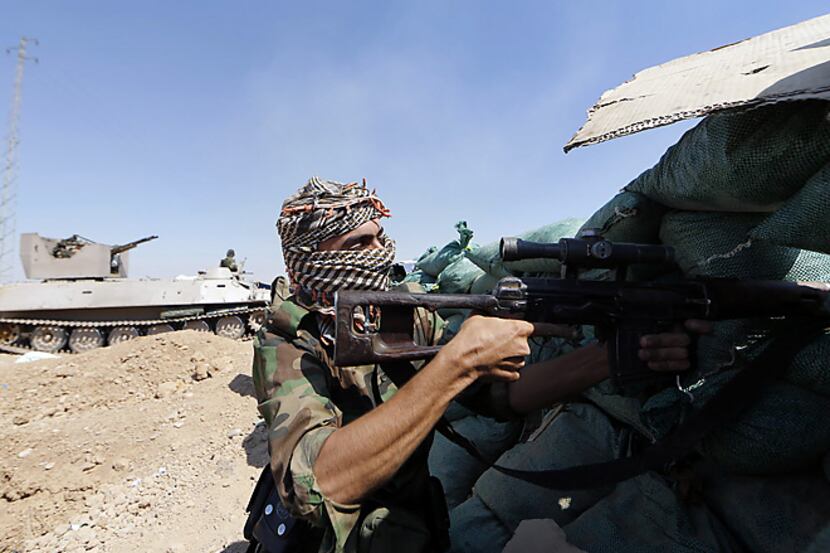 Iraqi Kurdish forces take positions Monday near Taza Khormato as they fight jihadist...