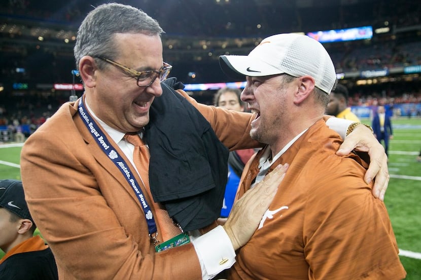 Texas athletic director Chris Del Conte congratulates Texas Head coach Tom Herman on the win...