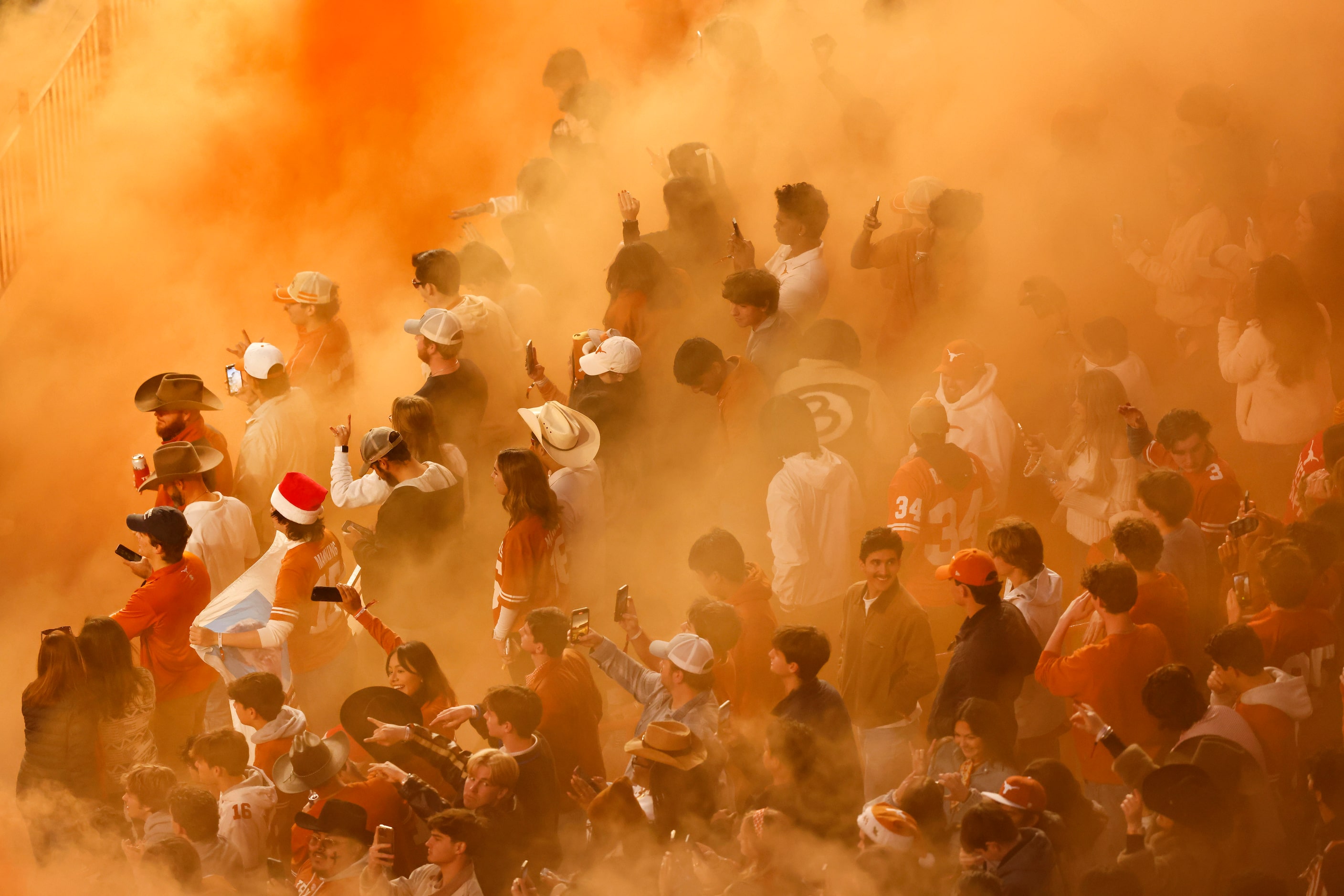 Orange smoke fills the student section following the third quarter of CFP first round...