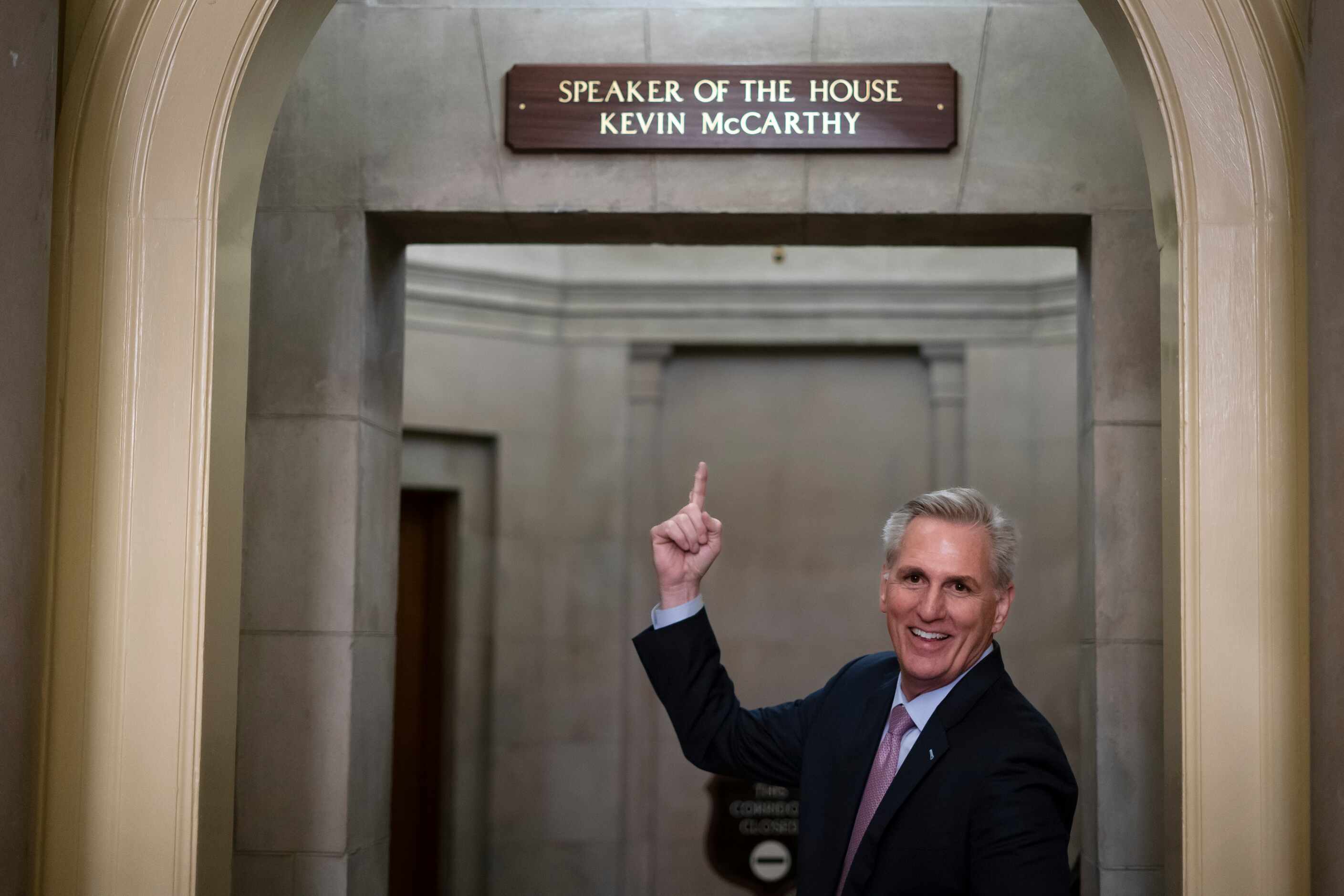 House Speaker Kevin McCarthy of Calif., gestures towards the newly installed nameplate at...
