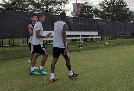 Kris Reaves (right) walks out to FC Dallas training with Reggie Cannon (center) and Brandon...