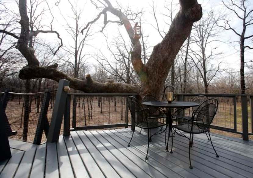 
A dining area outside a treehouse built by Pete Nelson for Bobby and Marty Page in...