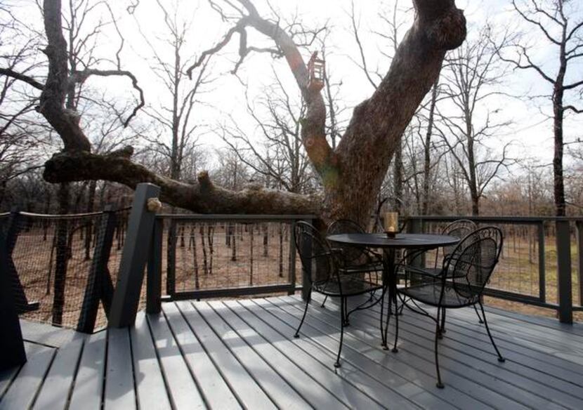 
A dining area outside a treehouse built by Pete Nelson for Bobby and Marty Page in...