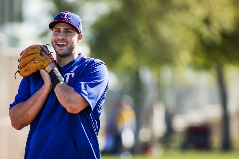 Texas Rangers infielder Joey Gallo laughs while participating in a defensive drill during a...
