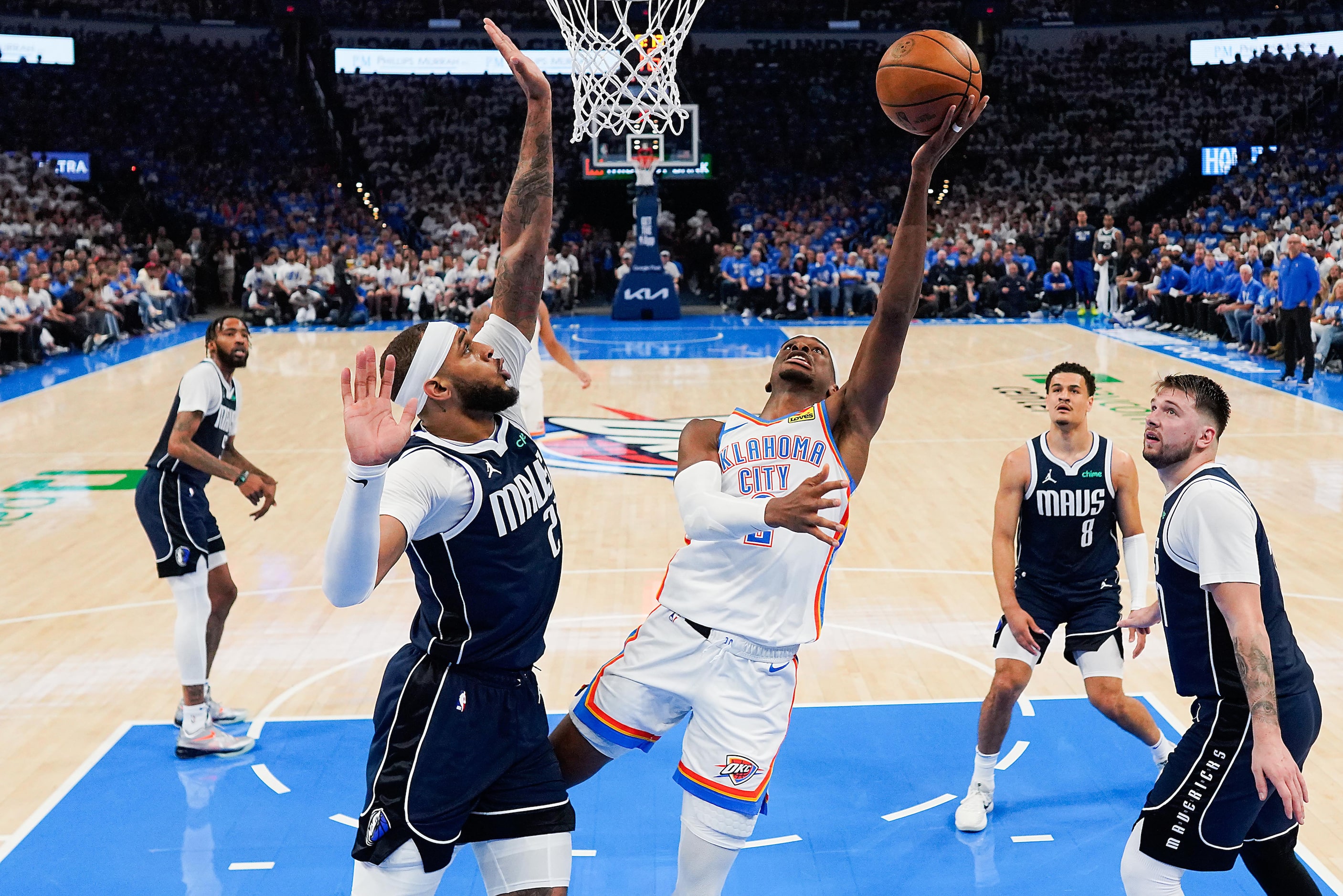 Oklahoma City Thunder guard Shai Gilgeous-Alexander (2) scores past Dallas Mavericks center...