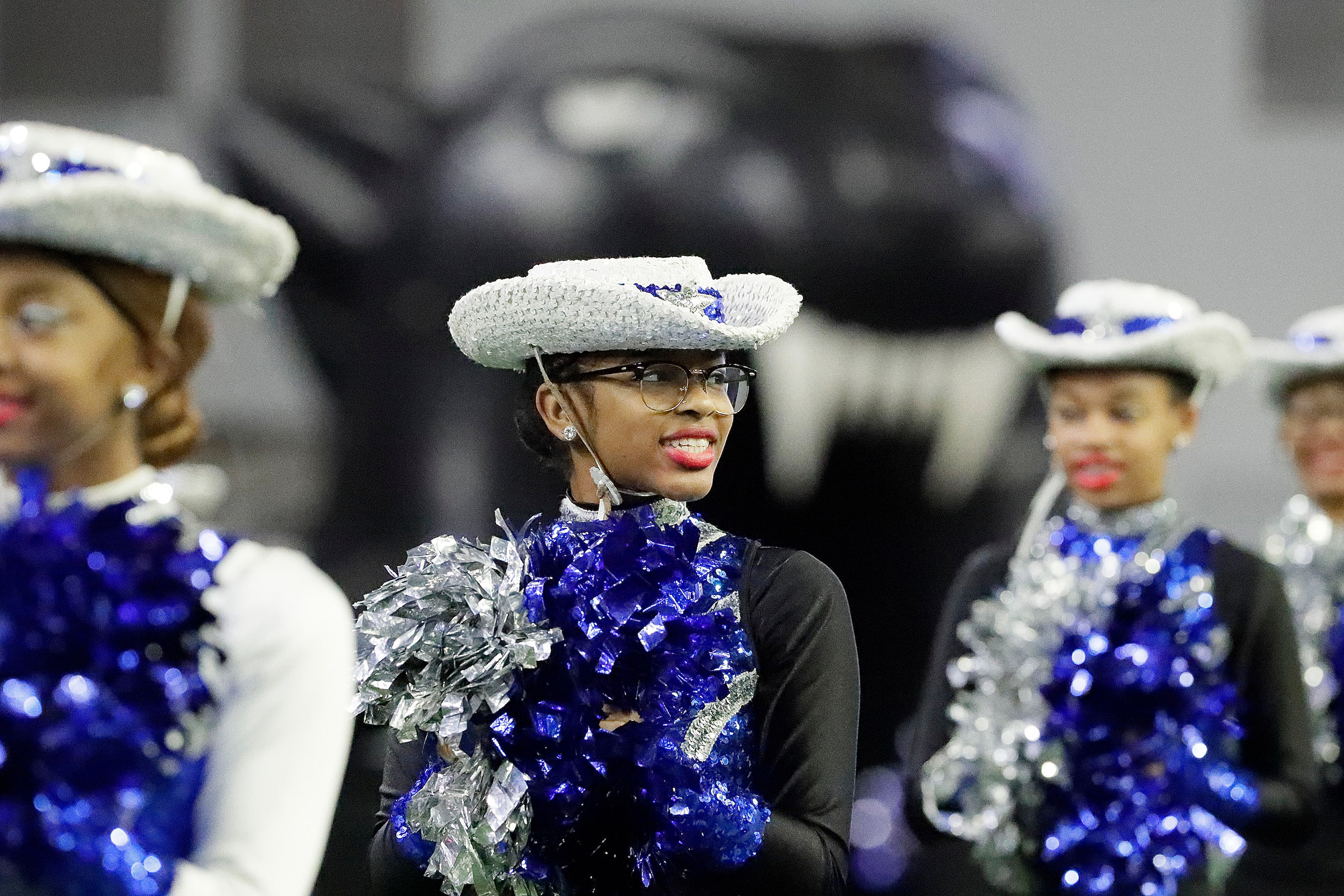 Kya Tuck, 17, with the North Crowley Silver Stars waits for the football team to take the...