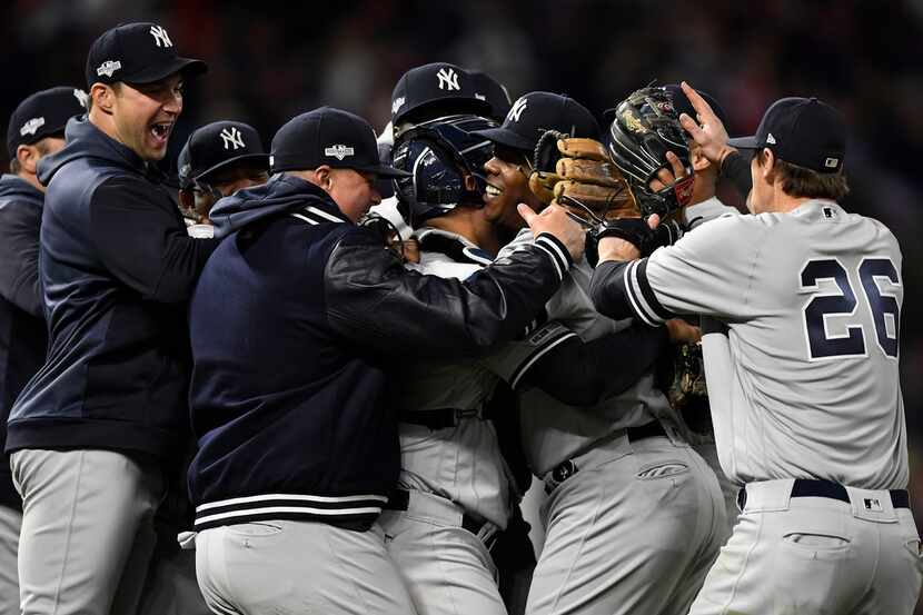 MINNEAPOLIS, MINNESOTA - OCTOBER 07: Aroldis Chapman #54 and the New York Yankees celebrate...