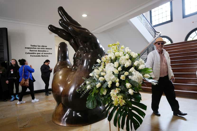 A floral arrangement stands next to the sculpture by Colombian artist Fernando Botero,...