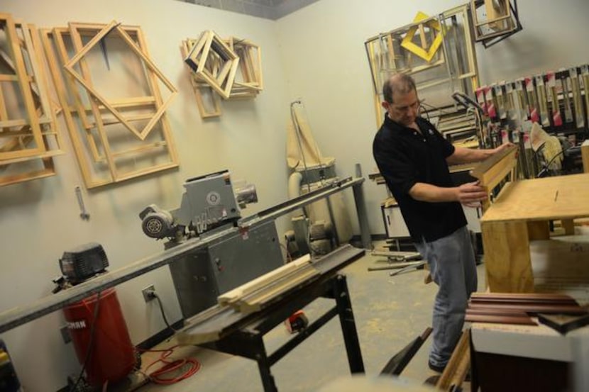 
Custom framer Kimbal Henderson measures a frame in the back room gallery. Pam Massar, who...