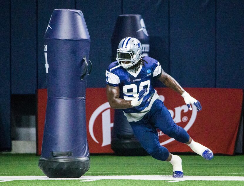 Dallas Cowboys defensive end Demarcus Lawrence (90) runs a drill during a Dallas Cowboys...