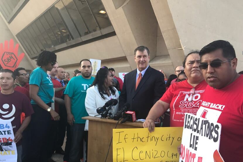 Dallas Mayor Mike Rawlings talks to opponents of SB4 during a Wednesday morning conference.