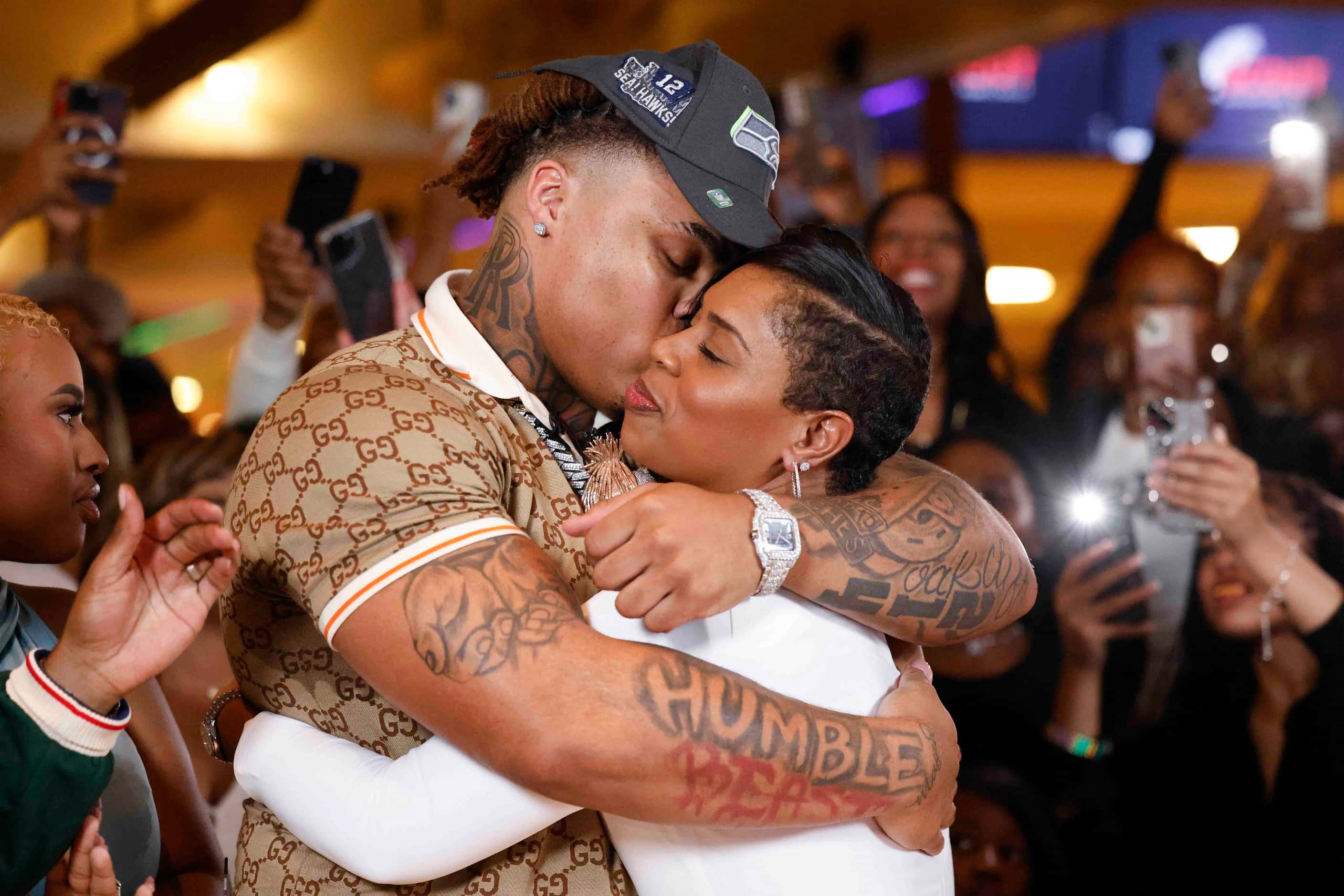 Texas defensive tackle Byron Murphy II, from DeSoto, kisses his mother, Seneca Murphy, after...