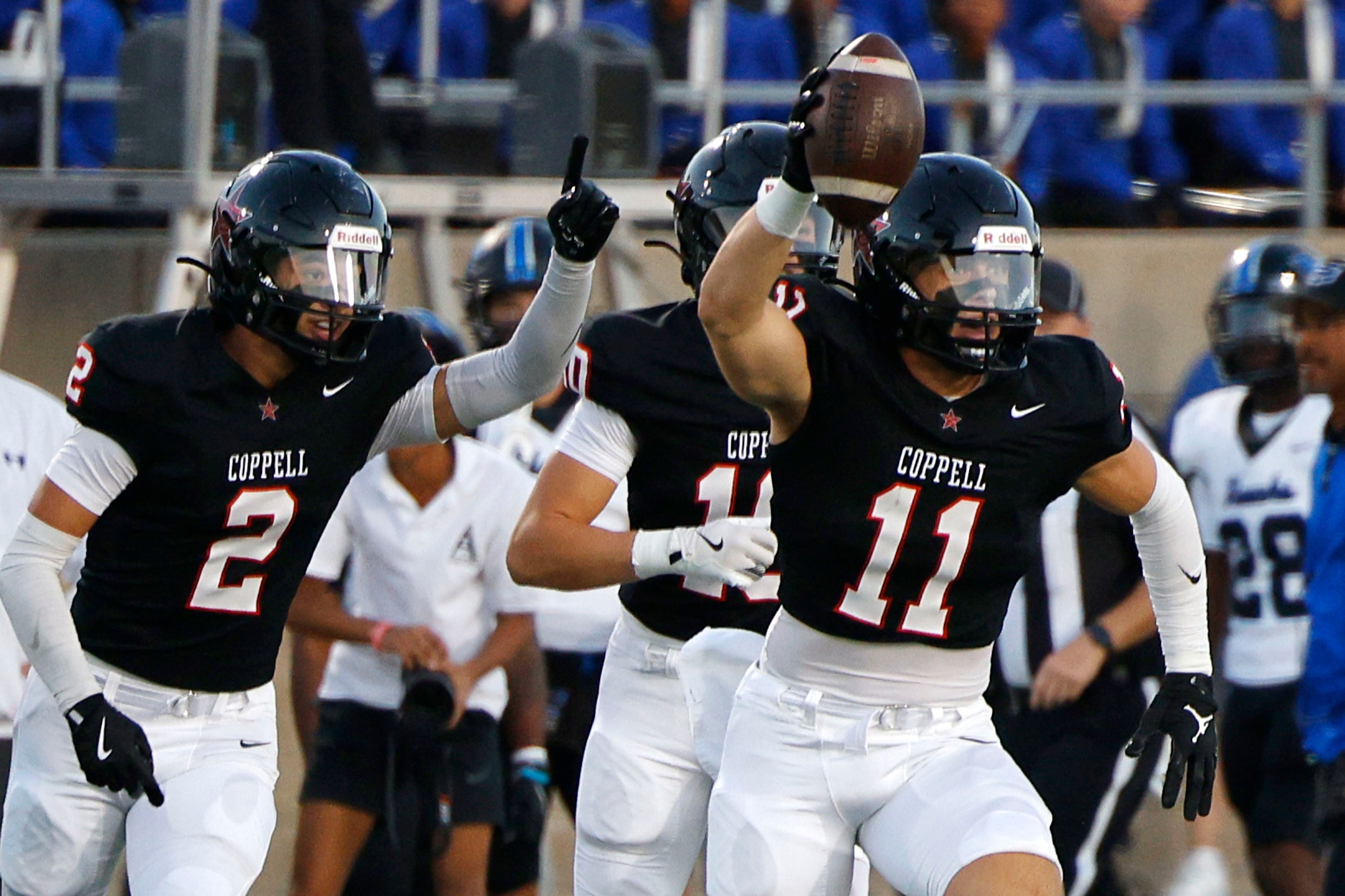 Coppell's Weston Polk (11) celebrates with his teammates Matthew Neitzel (2) and Alex Kraus...