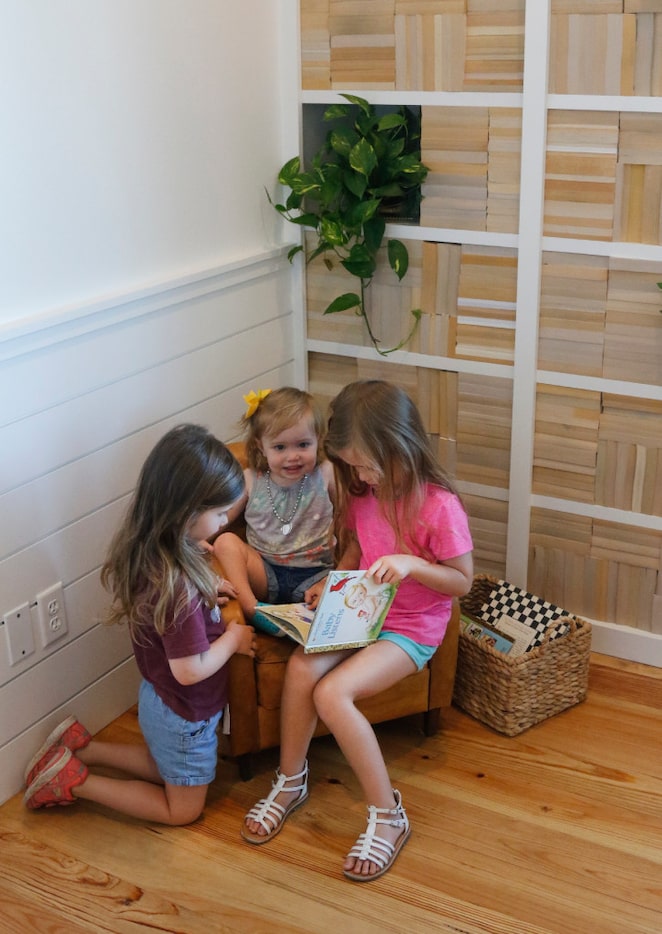 From left, Susanna Warren, 3, Kathryn Warren, 23 months,  and Avery Warren, 5, look over a...