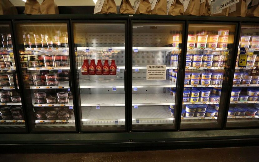 Shelves sit empty of Blue Bell ice cream at a grocery store in Dallas on Tuesday.