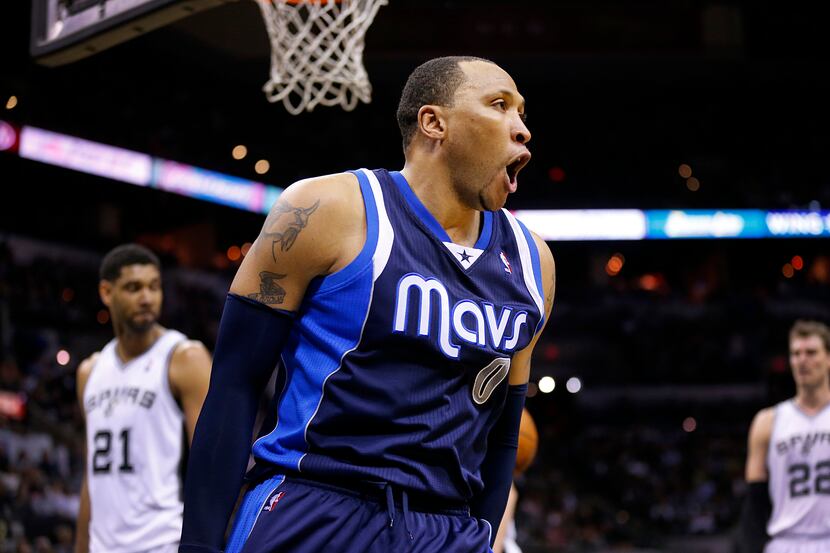 Dallas Mavericks forward Shawn Marion (0) shows his excitement after throwing down a first...