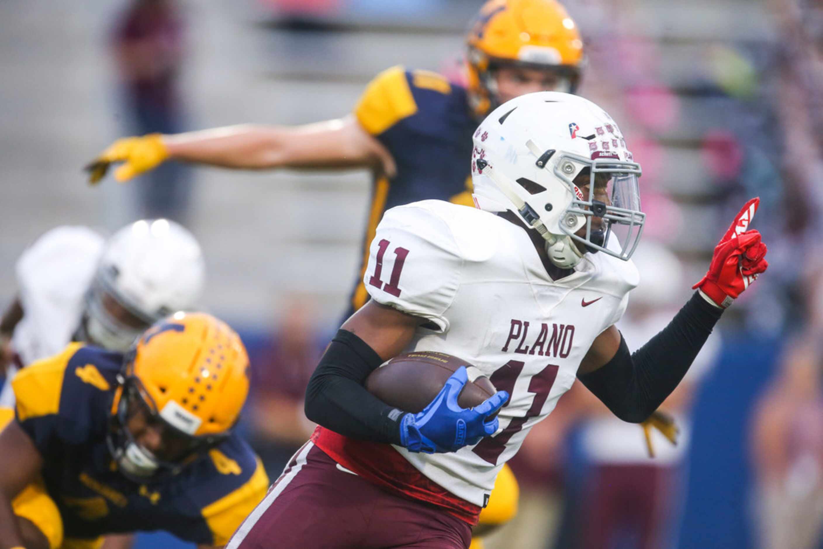 Plano wide receiver Isaiah Calhoun (11) returns a punt for a touchdown during the first half...