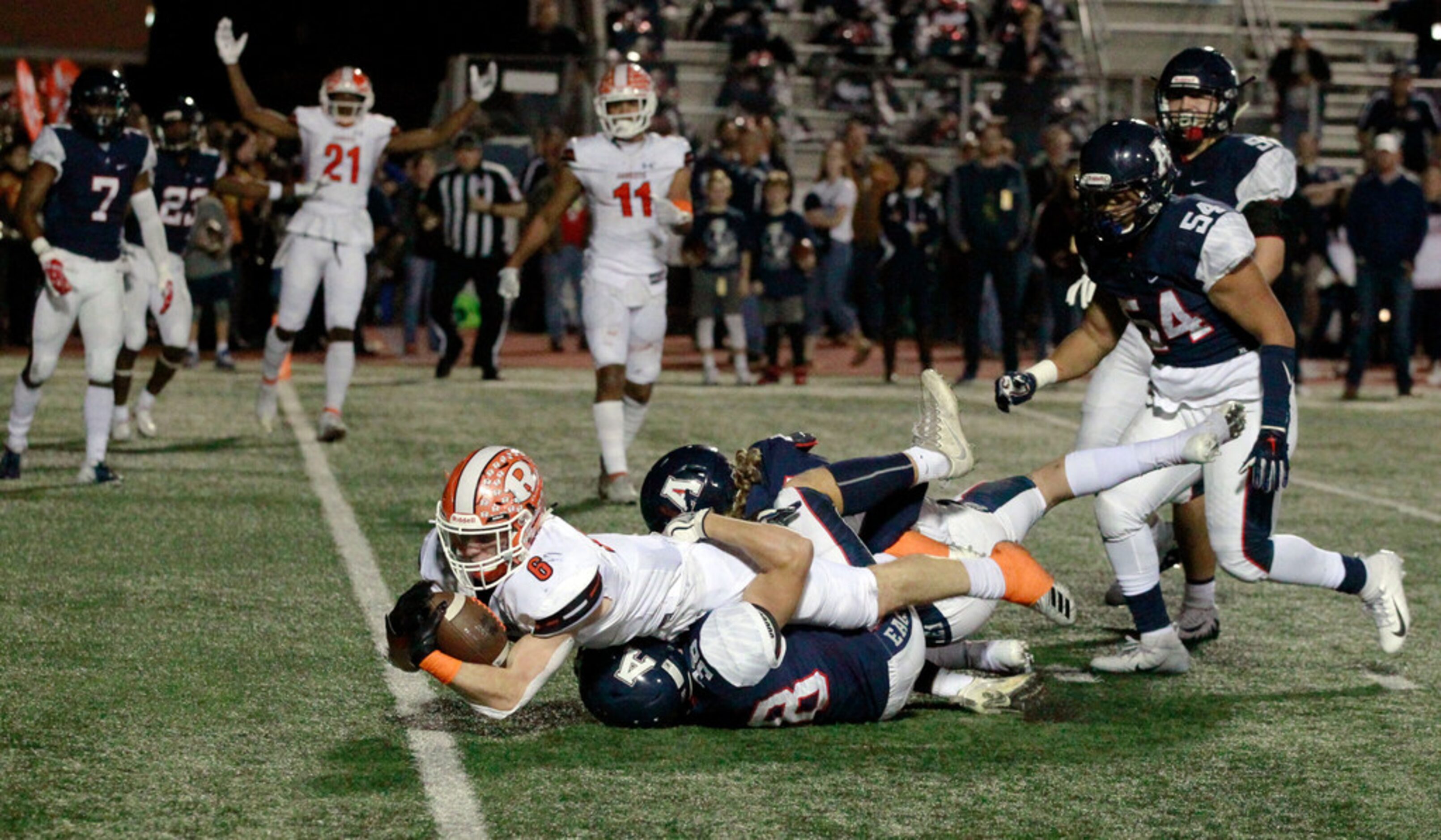 Rockwall's Zach Henry (6) scores a touchdown aver a couple of Allen defenders during the...