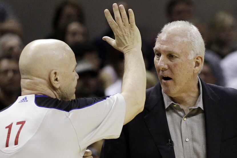 San Antonio Spurs head coach Gregg Popovich, right, discusses a play with referee Joe...