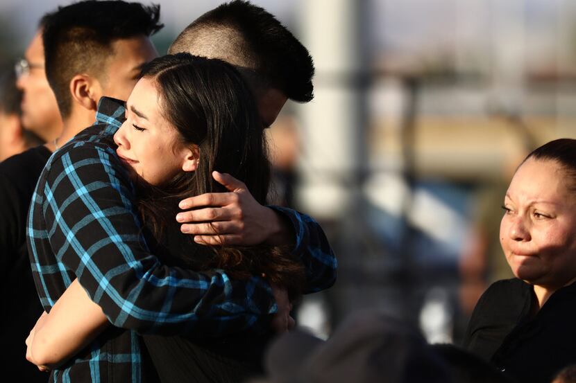 Mourners embrace at a vigil honoring Horizon High School sophomore Javier Amir Rodriguez,...