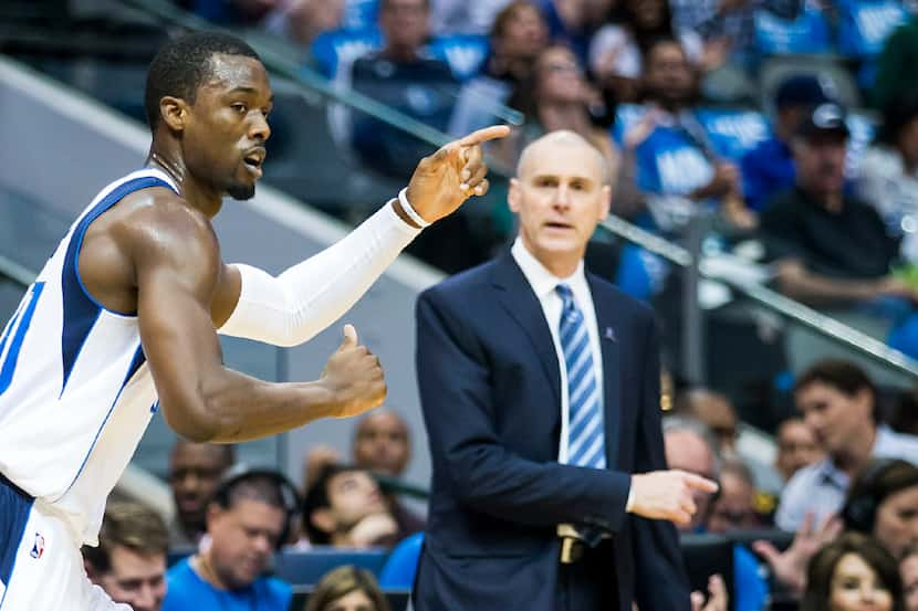 Dallas Mavericks forward Harrison Barnes celebrates after making a 3-pointer in front of...