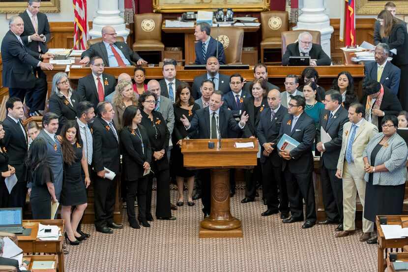 Dallas Democrat Rafael Anchia  gathered at the podium with other House members to oppose...