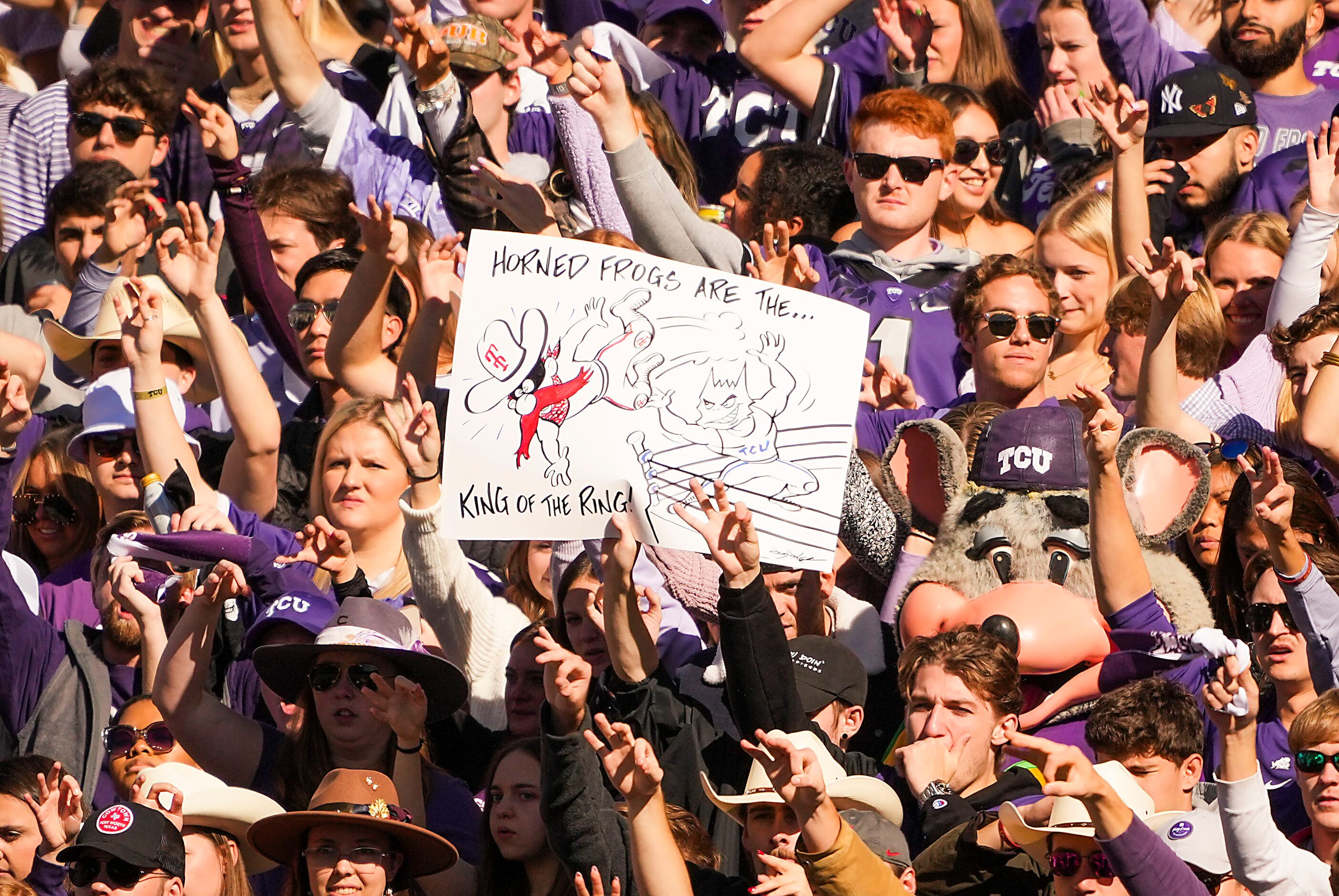 TCU fans cheer their team during the first half of an NCAA football game against Texas Tech...