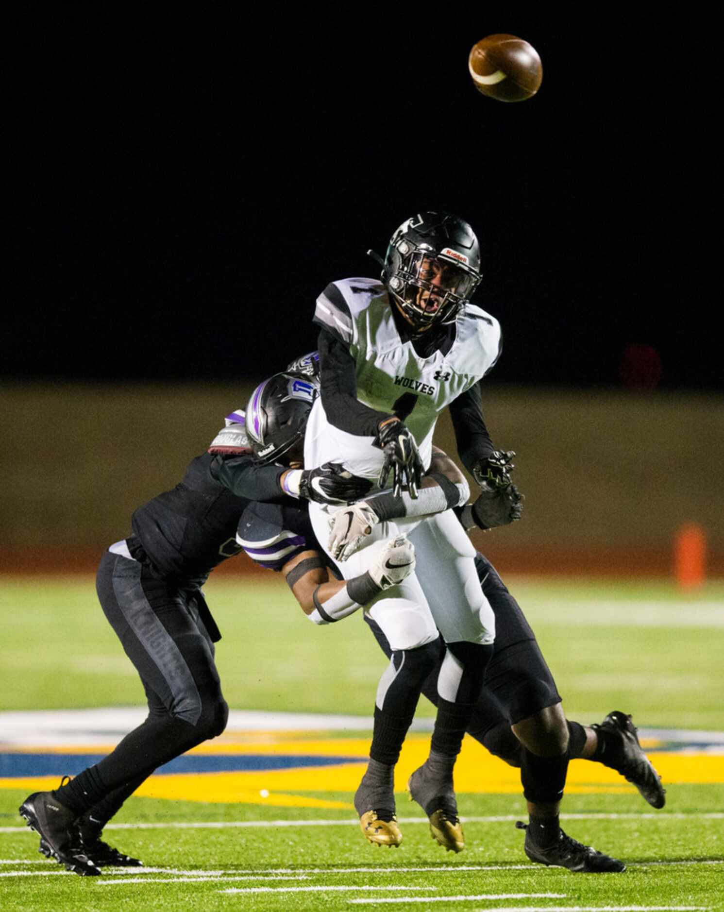 Mansfield Timberview running back Stacy Sneed (1) gets out a pass while being tackled by...