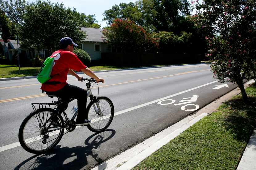 A man rides down a bike lane in East Dallas in 2019.