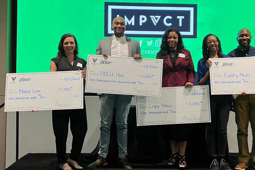 Impact Ventures awards grants to LEAP participants, holding checks.