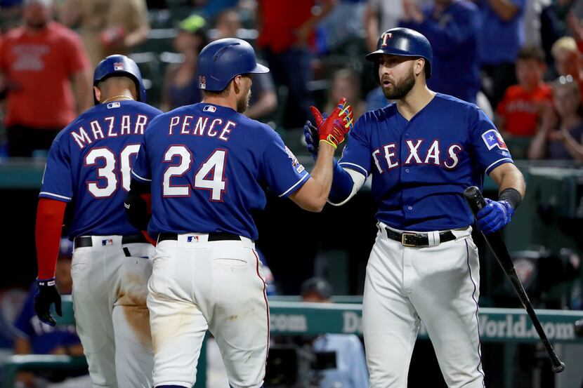 ARLINGTON, TEXAS - MAY 20: Hunter Pence #24 of the Texas Rangers celebrates with Joey Gallo...