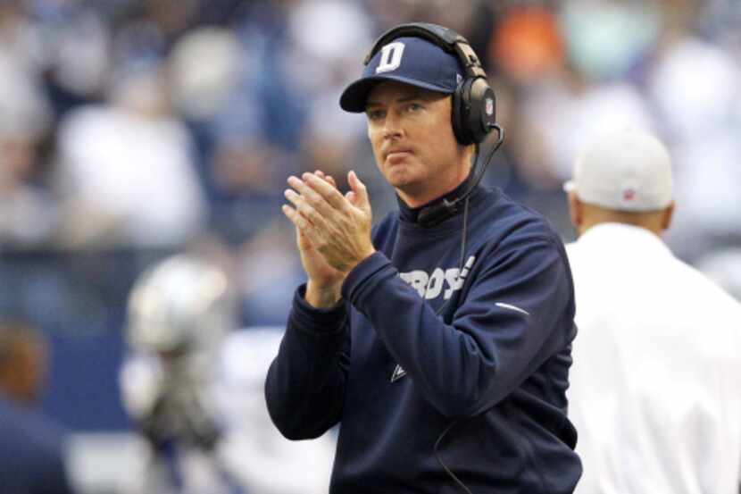 Dallas Cowboys head coach Jason Garrett applauds his team after they scored a touchdown...
