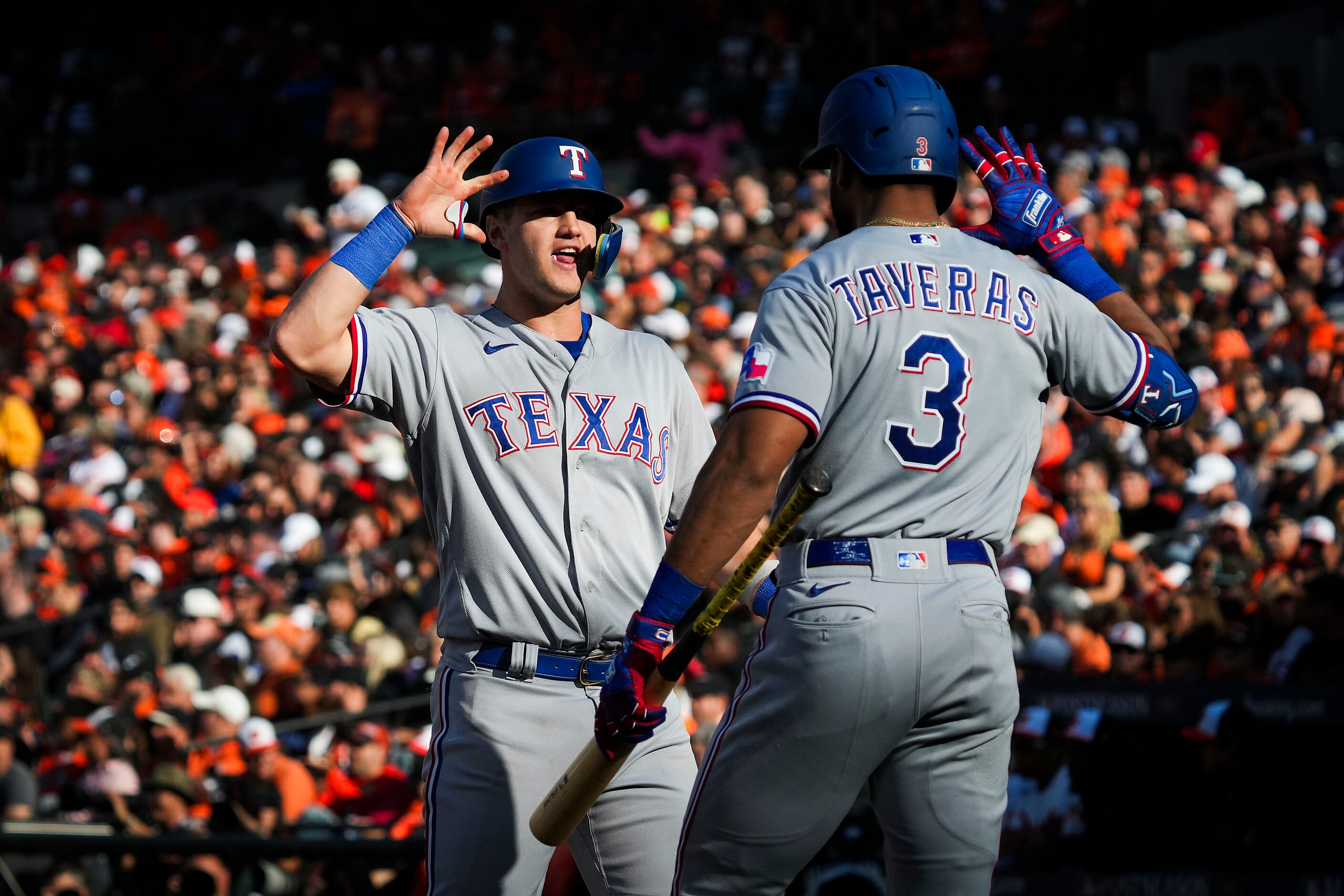 Texas Rangers third baseman Josh Jung celebrates with center fielder Leody Taveras (3) after...