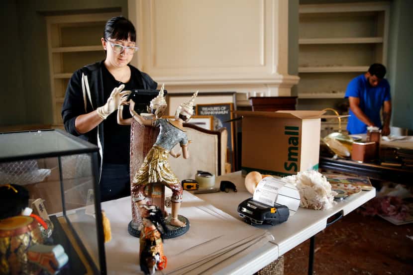 Nina Klaser (left) of Art of Dallas-Fort Worth, an art recovery and restoration company,...
