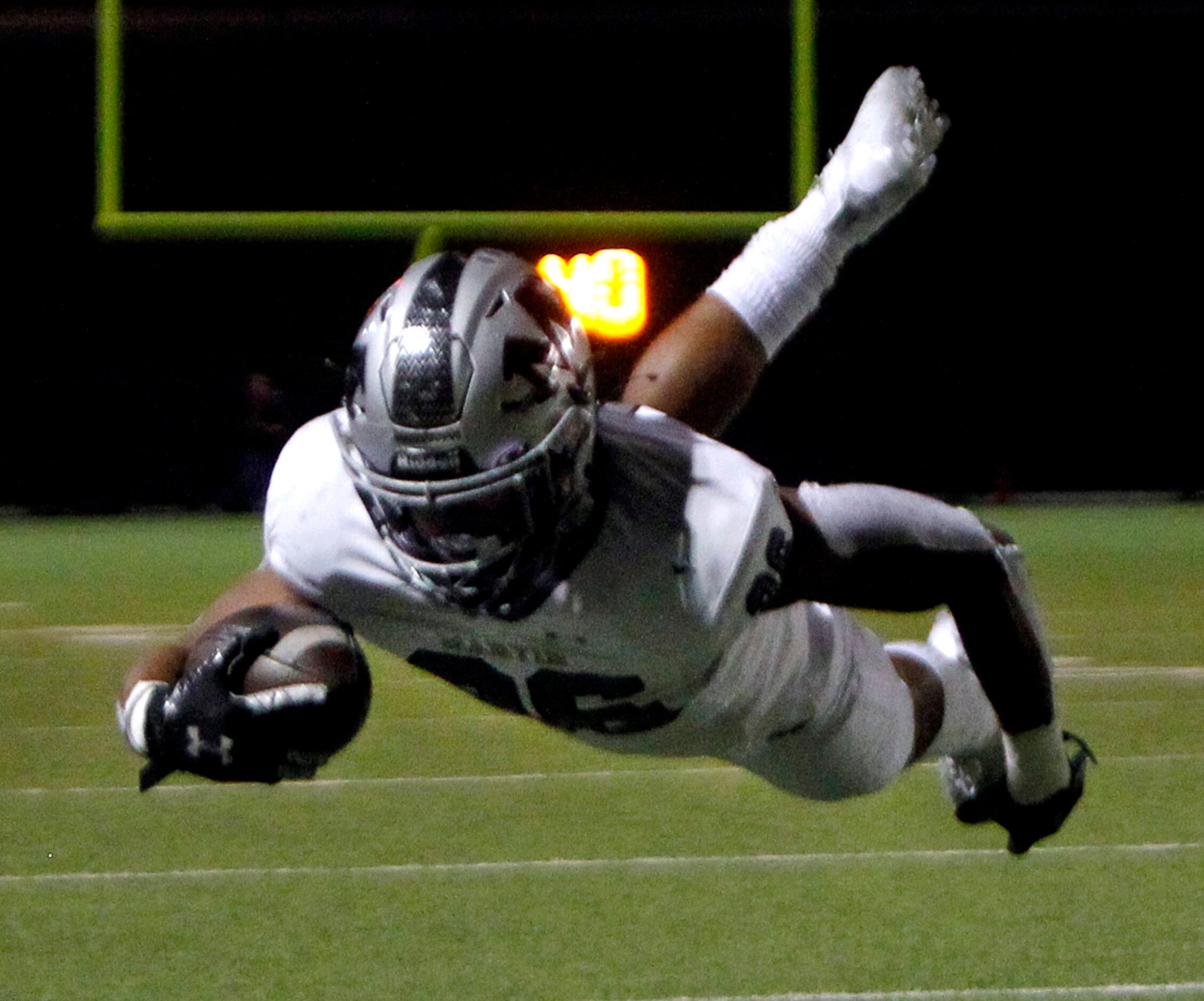 Arlington Martin running back Sergio Snider (26) dives for a first down during a second...